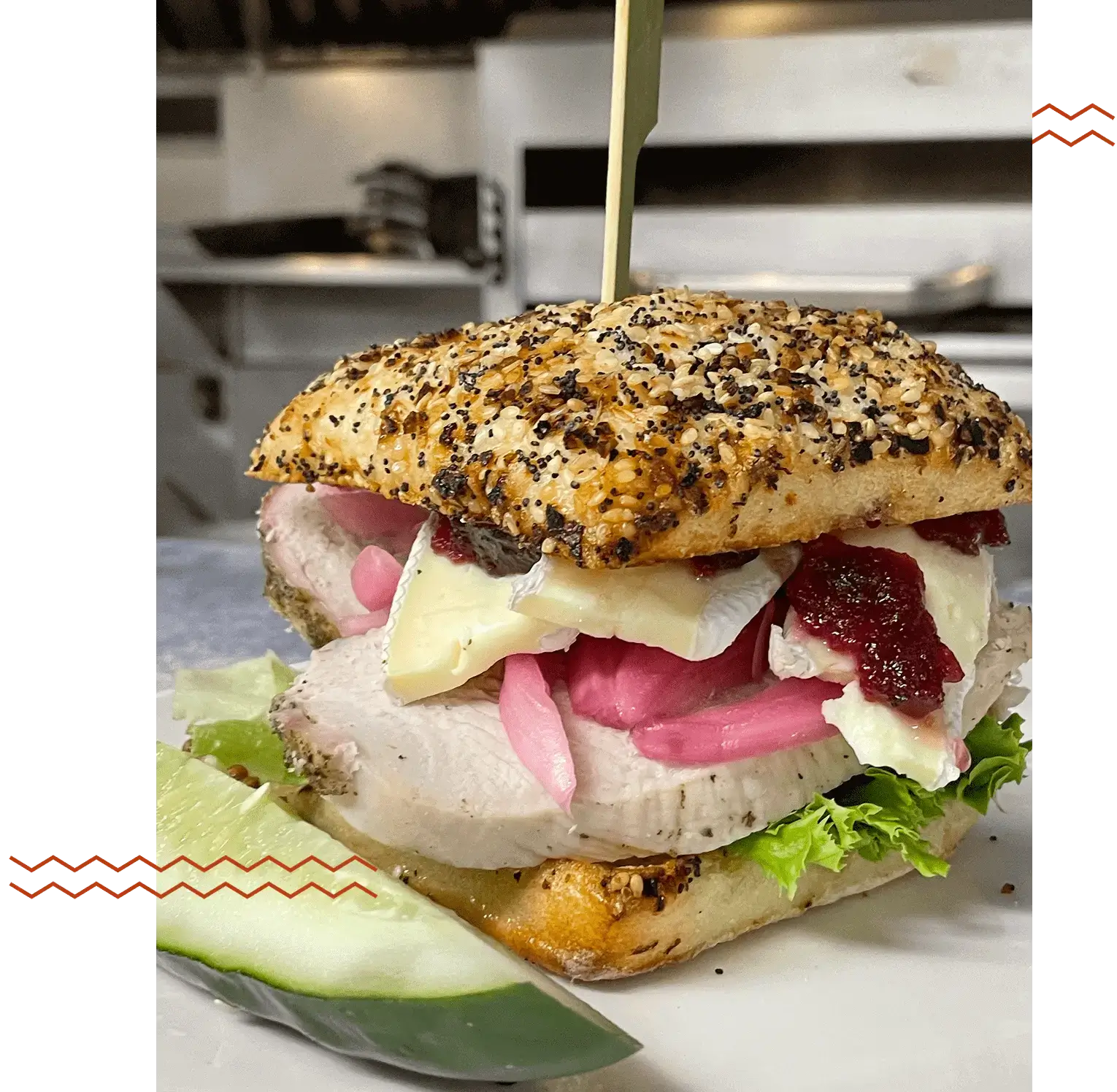 A gourmet sandwich with various fresh ingredients on seeded bread.